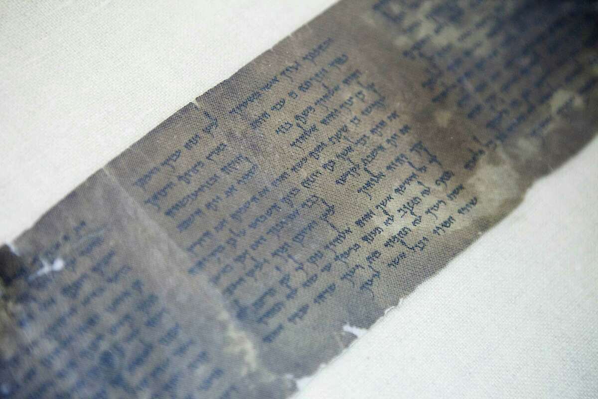 FILE - This Friday, May 10, 2013 file photo shows the world’s oldest complete copy of the Ten Commandments, written on one of the Dead Sea Scrolls in Jerusalem. The manuscript is on rare display at Israel’s national museum in an exhibit of objects from pivotal moments in the history of civilization.