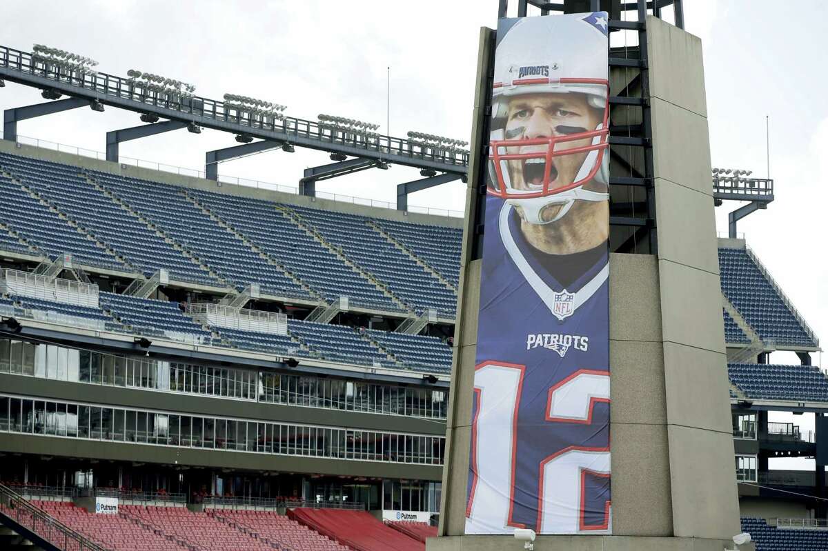 A oversized banner of New England Patriots’ Tom Brady is attached to the lighthouse at an entrance to Gillette Stadium.