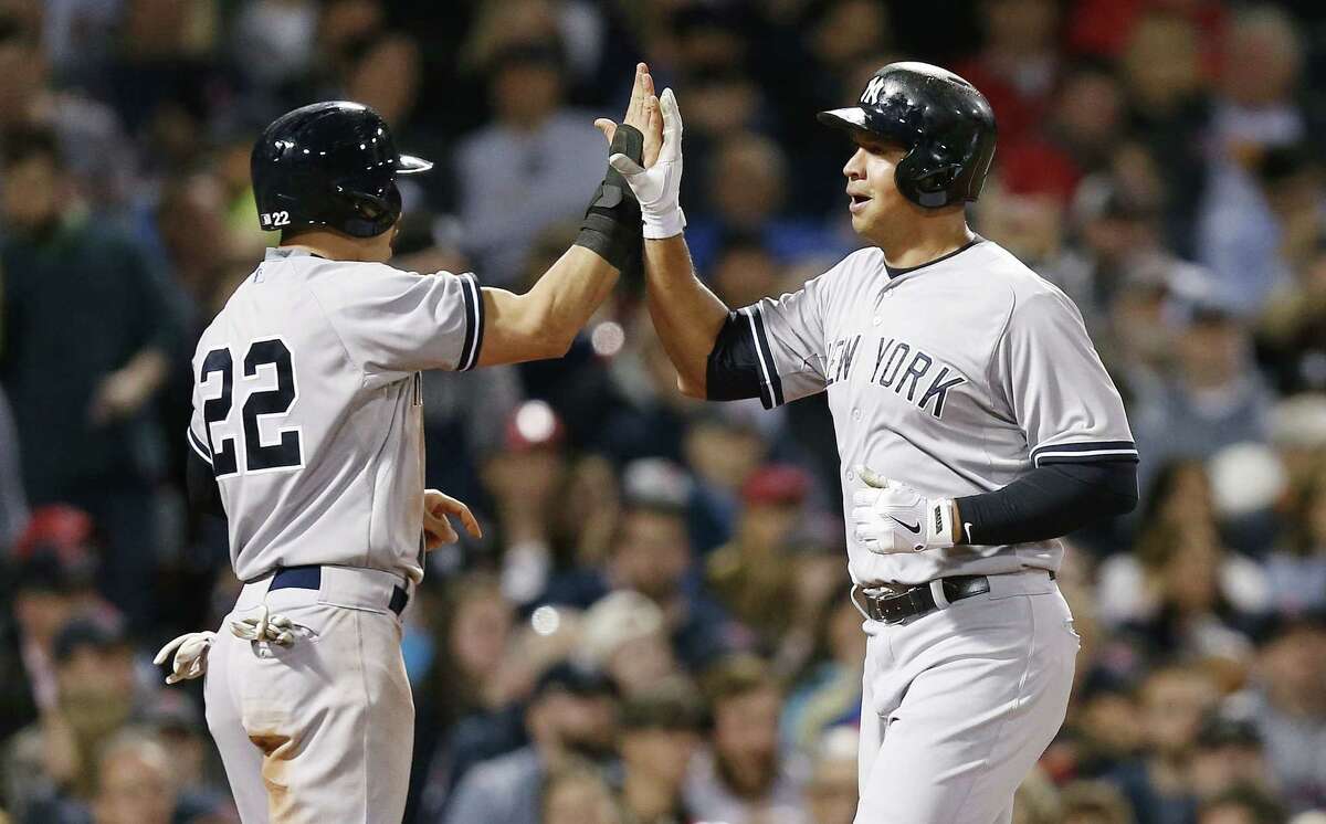 The Yankees’ Alex Rodriguez, right, celebrates after scoring with Jacoby Ellsbury on a two-run double by Brian McCann during the third inning on Sunday.