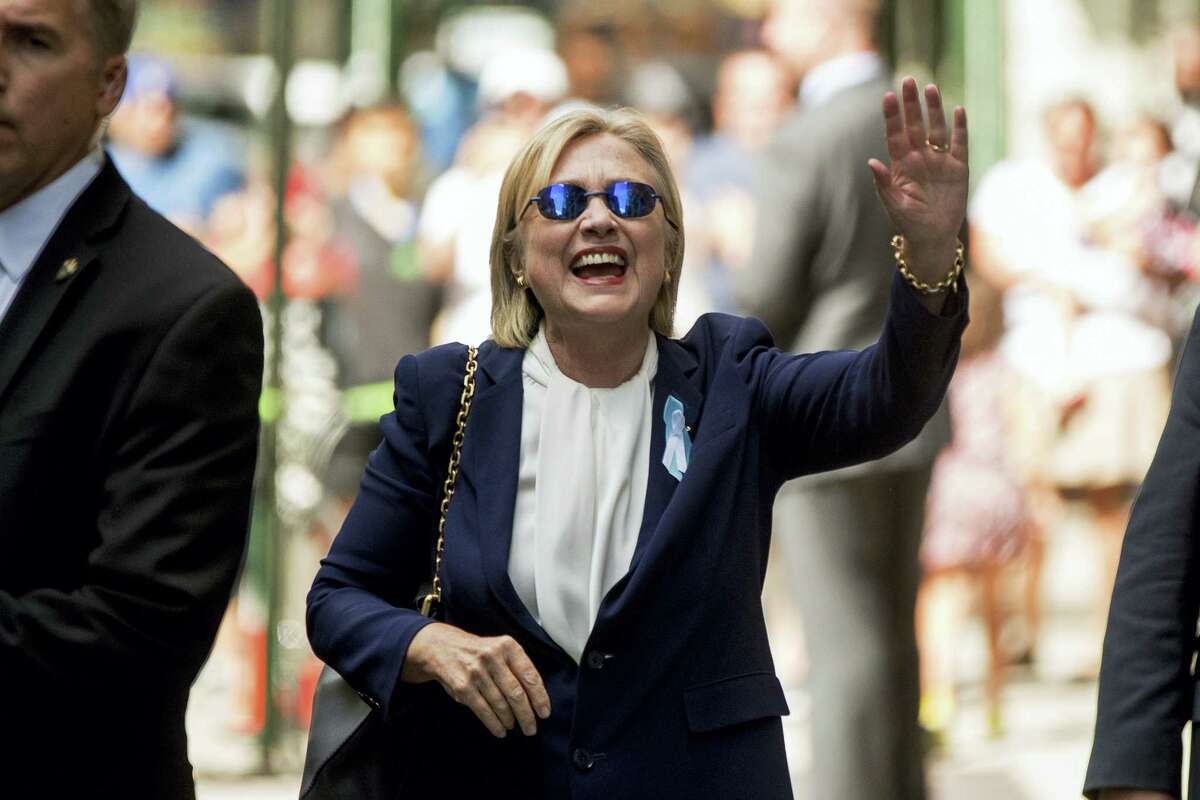 Democratic presidential candidate Hillary Clinton waves after leaving an apartment building on Sept. 11, 2016, in New York. Clinton’s campaign said the Democratic presidential nominee left the 9/11 anniversary ceremony in New York early after feeling “overheated.”