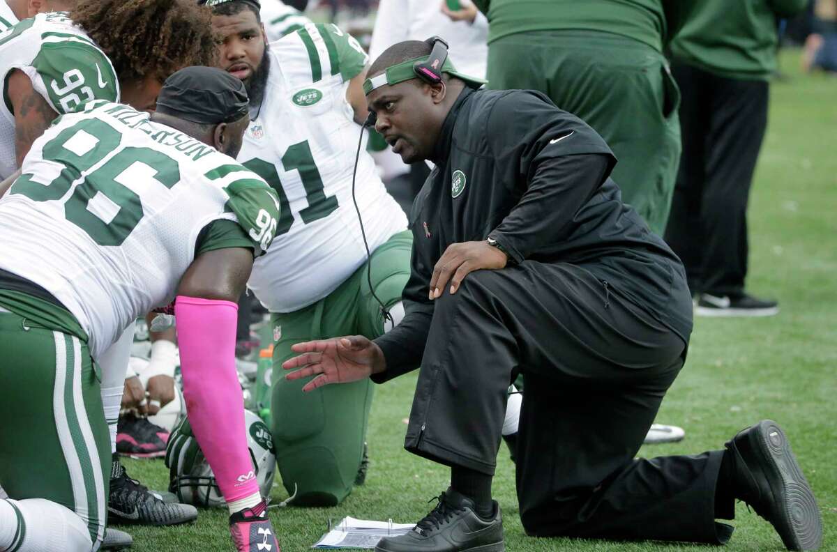 New York Jets defensive coordinator Kacy Rodgers talks to defensive end Muhammad Wilkerson (96) on the sideline during last Sunday’s game against the New England Patriots in Foxborough, Mass.
