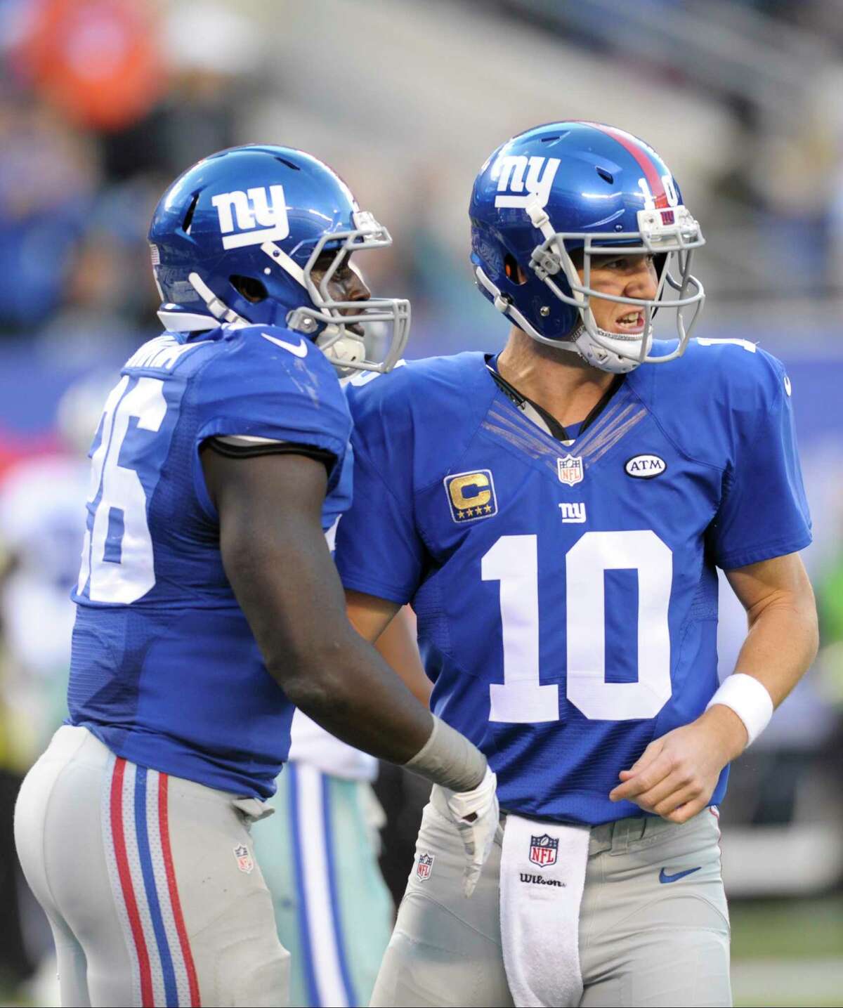 New York Giants running back Orleans Darkwa (26) celebrates with quarterback Eli Manning after rushing for a touchdown against the Dallas Cowboys last Sunday in East Rutherford, N.J.