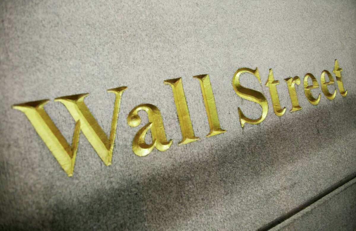 FILE - This Oct. 8. 2014 photo shows a Wall Street address on the side of a building in New York. U.S. stocks opened higher Monday, May 4, 2015, pushing stocks to record levels, as investors assessed corporate earnings.
