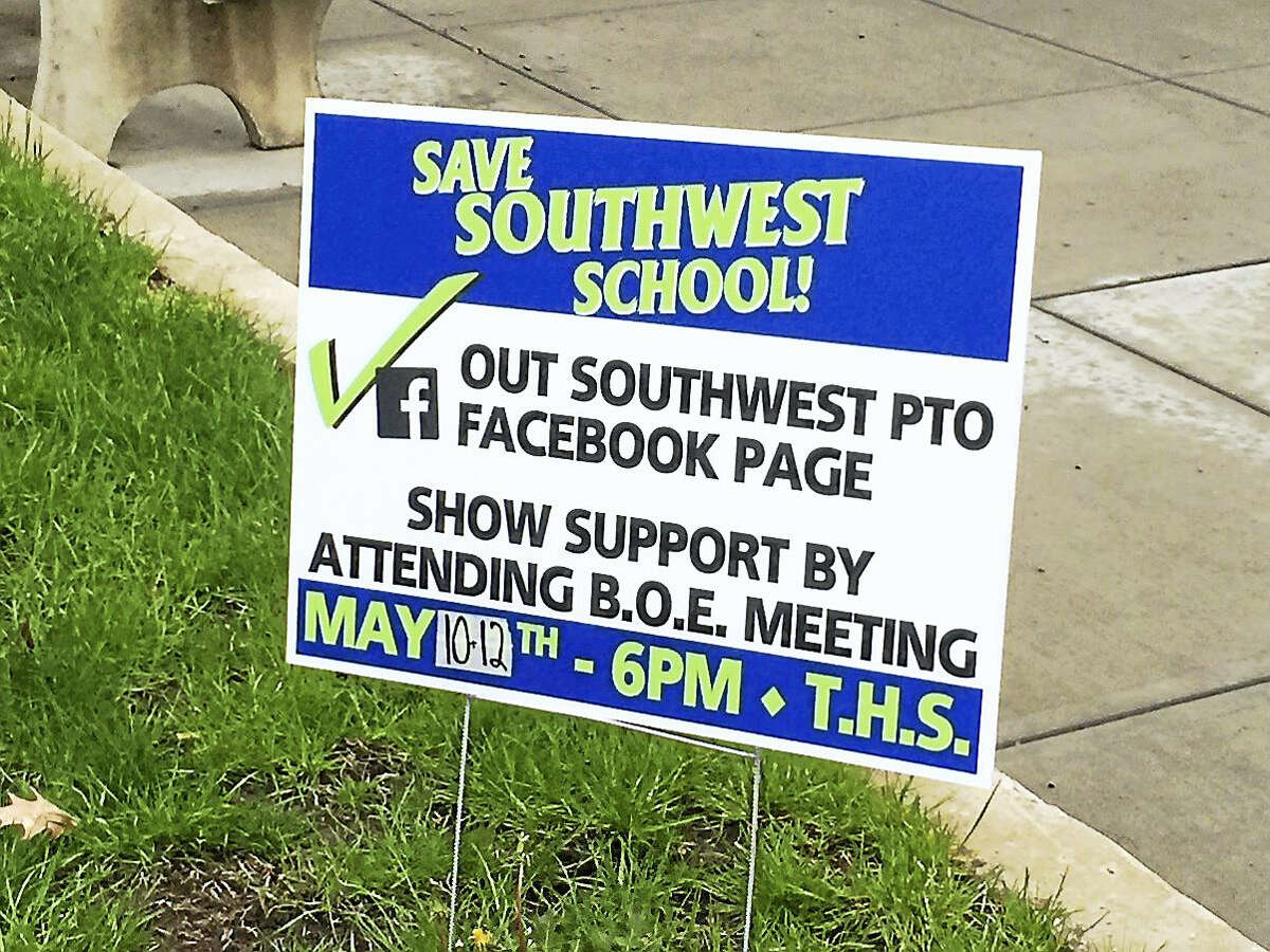 A sign urging residents to support keeping Southwest School open, as displayed recently on the lawn of City Hall in Torrington.