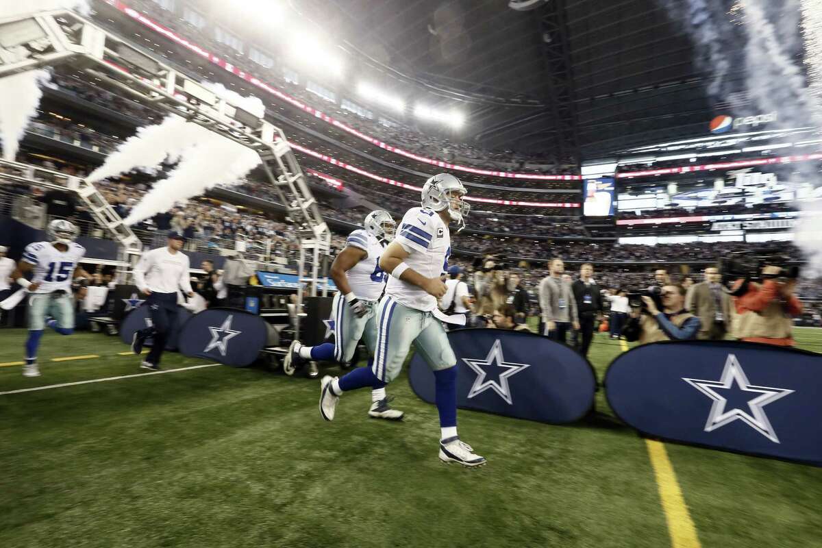 Dallas quarterback Tony Romo leads the Cowboys onto the field before a Dec. 21 game against the Indianapolis Colts in Arlington, Texas.