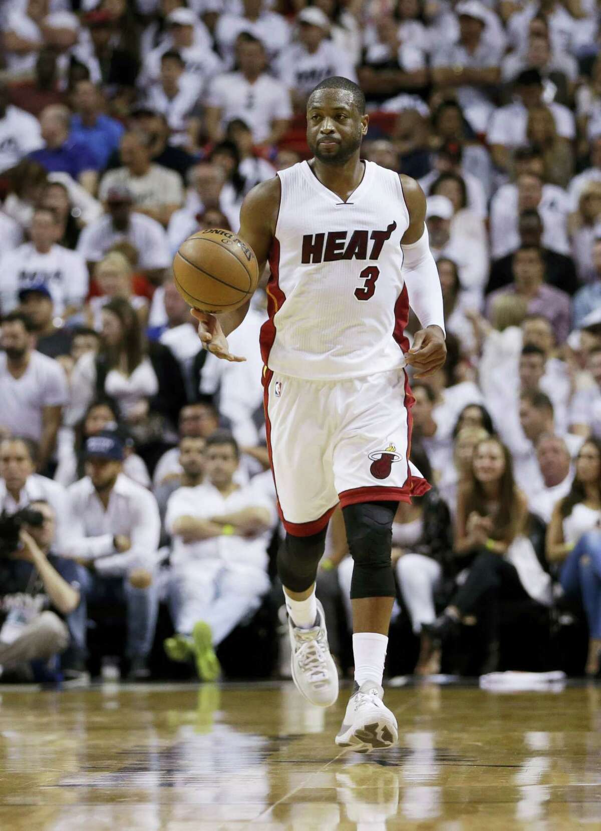 Miami Heat guard Dwyane Wade dribbles up the court during Game 3 against the Raptors on Saturday.