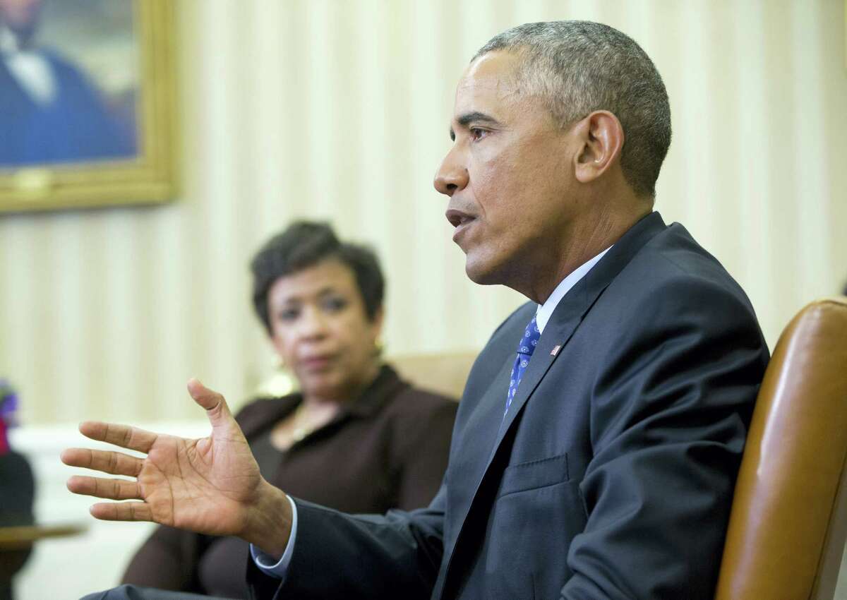 Attorney General Loretta Lynch listens as President Barack Obama speaks in the Oval Office of the White House in Washington, Monday, Jan. 4, 2016, during a meeting with law enforcement officials to discuss executive actions the president can take to curb gun violence. The president is slated to finalize a set of new executive actions tightening U.S. gun laws, kicking off his last year in office with a clear signal that he intends to prioritize one of the country's most intractable issues. (AP Photo/Pablo Martinez Monsivais)