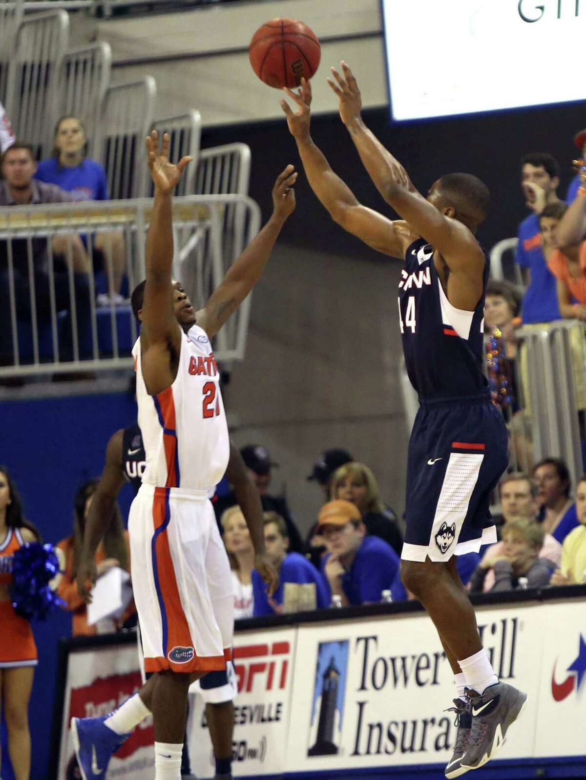 UConn’s Rodney Purvis knocks down a 3-pointer over Florida’s Michael Frazier II late in the second half of the Huskies’ 63-59 win on Saturday in Gainesville, Fla.