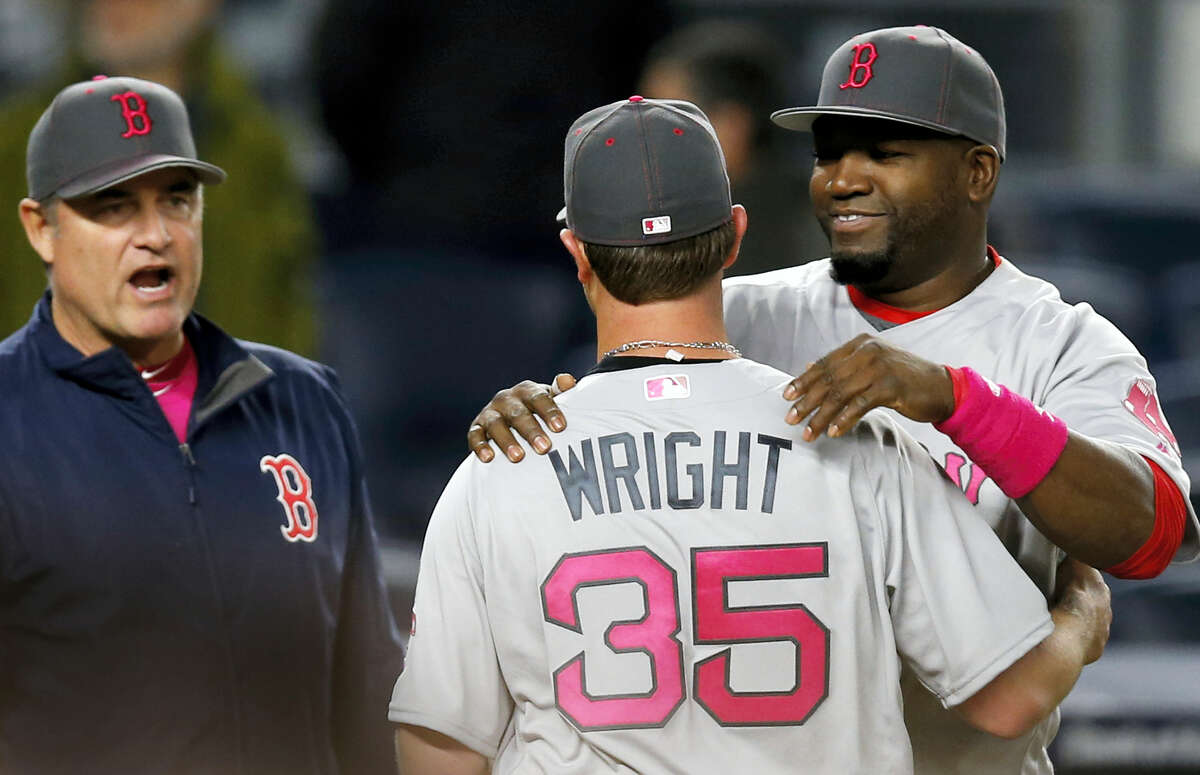 Red Sox manager John Farrell, left, and designated hitter David Ortiz, right, congratulate Steven Wright after Sunday’s game. Wright allowed just three hits in a 5-1 win over the Yankees.