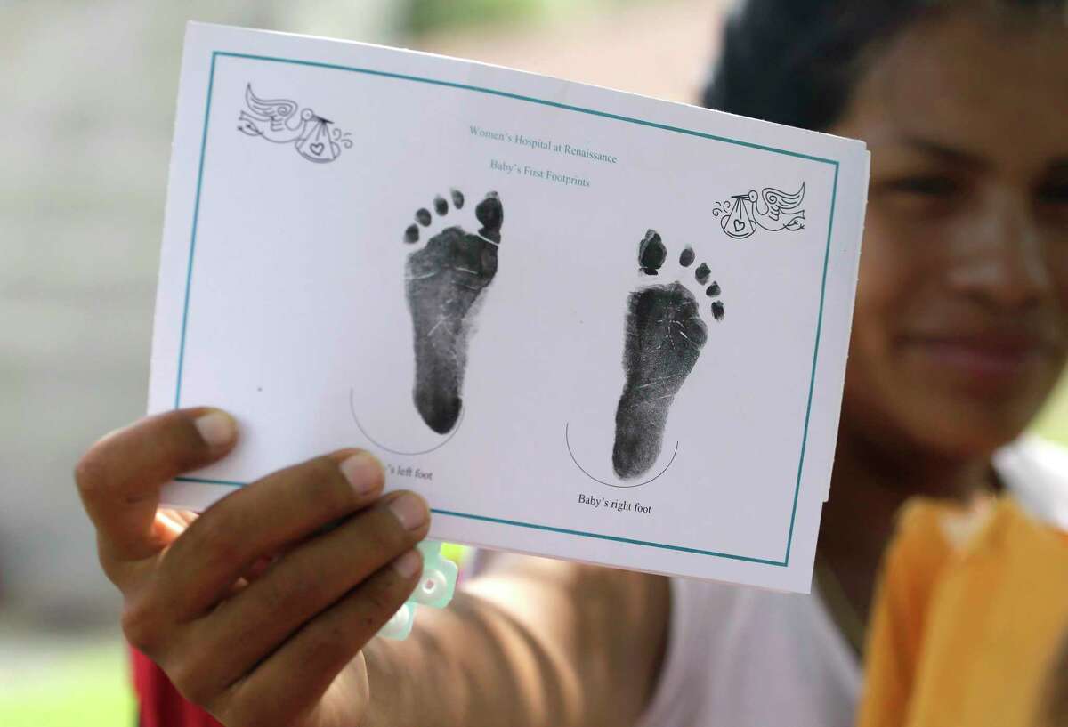 In this Sept. 16, 2015, photo, a woman who said she entered the country illegally, shows in Sullivan City, Texas, the foot prints of her daughter who was born in the United State but was denied a birth certificate. A federal judge has chosen for now not to force Texas health officials to change their stance in denying birth certificates to immigrant families with U.S- born children, saying that the families raised “grave concerns” but more evidence is needed, according to a ruling issued Friday, Oct. 16.