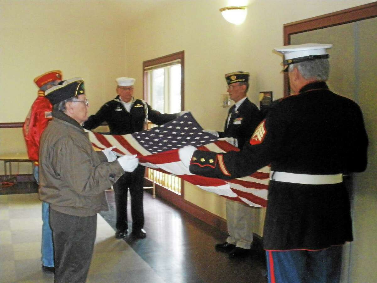 Family members and veterans honor deceased U.S. Navy Korean War veteran Calvin Warner Strong at the Veteran of the Month ceremony in Bantam. Photo by Stephen Underwood