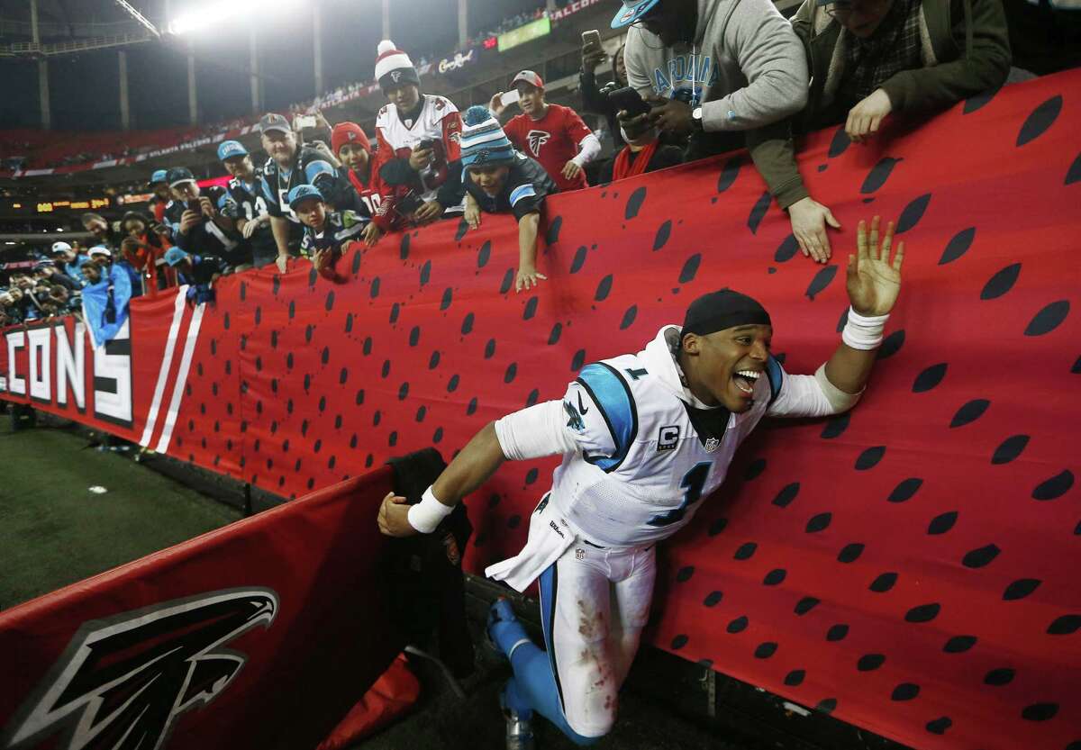 Carolina quarterback Cam Newton greets fans after the Panthers’ 34-3 win over the Falcons on Sunday in Atlanta.