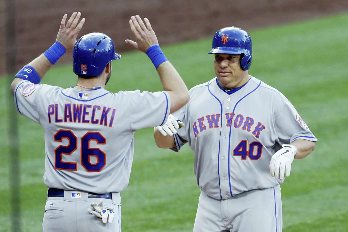 The Mets’ Bartolo Colon, right, is greeted by teammate Kevin Plawecki (26) after hitting a two-run home run during the second inning on Saturday.