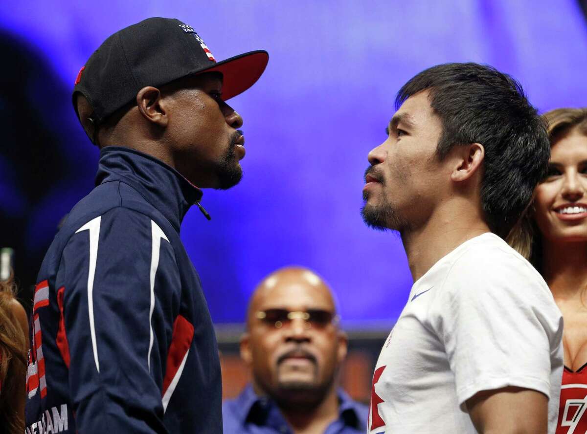Floyd Mayweather Jr., left, and Manny Pacquiao pose during their weigh-in on Friday in Las Vegas.
