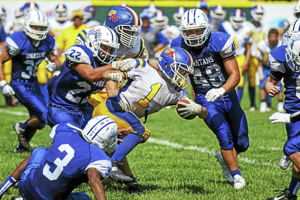 At 5-10, 155 pounds, G/N’s Billy Komons gritted through two rushing touchdowns and a scoring interception return on a blistering hot day at Muzzy field.