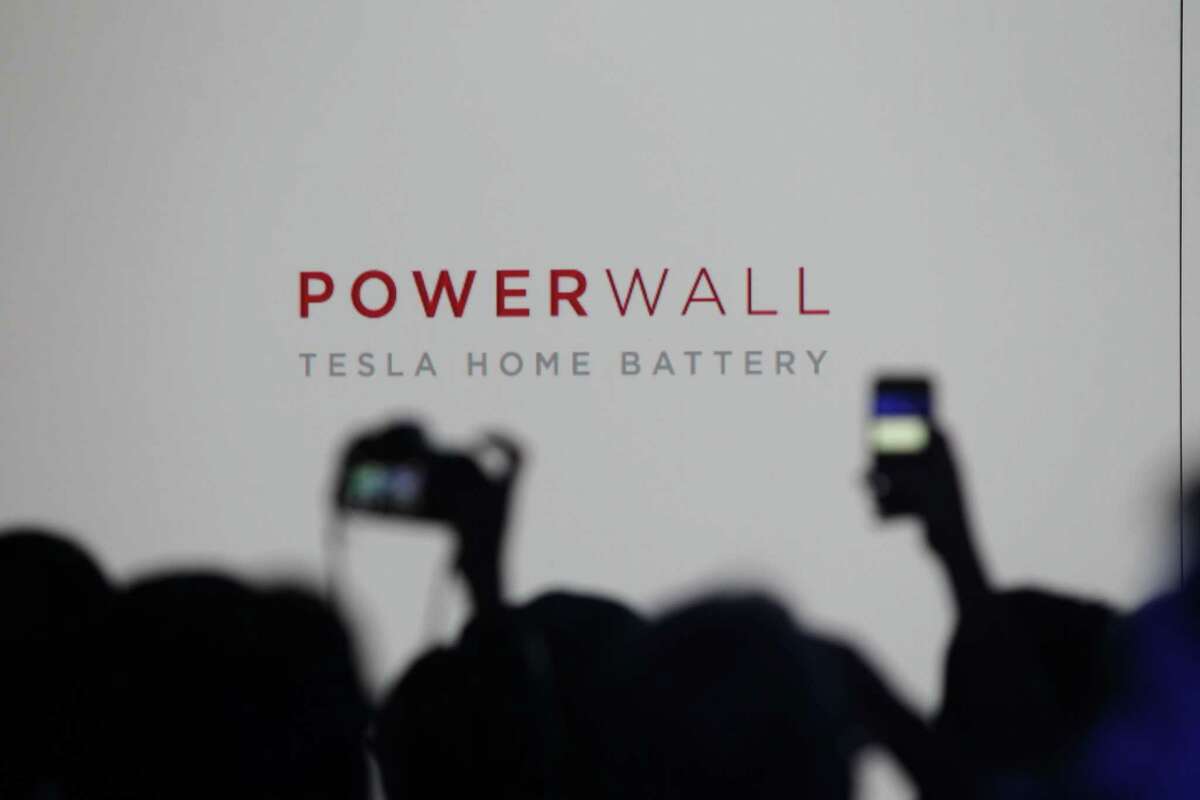Media members and guests wait for the Tesla Motors Inc. to announce its expansion into the home battery market in Hawthorne, Calif., Thursday, April 30, 2015. Tesla CEO Elon Musk is trying to steer his electric car company's battery technology into homes and businesses as part of an elaborate plan to reshape the power grid with millions of small power plants made of solar panels on roofs and batteries in garages. (AP Photo/Ringo H.W. Chiu)