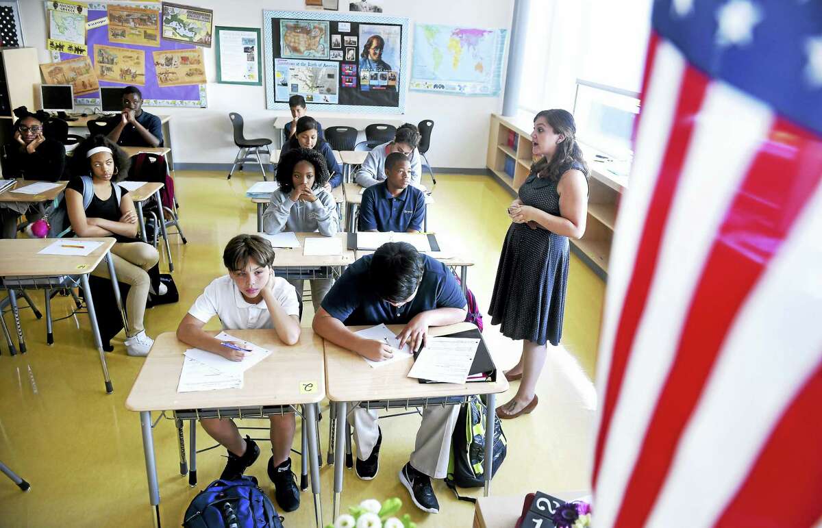 Laura Generoso, right, leads an eighth grade Social Studies class about the 9/11 attacks on the World Trade Center at East Rock Community Magnet School in New Haven.