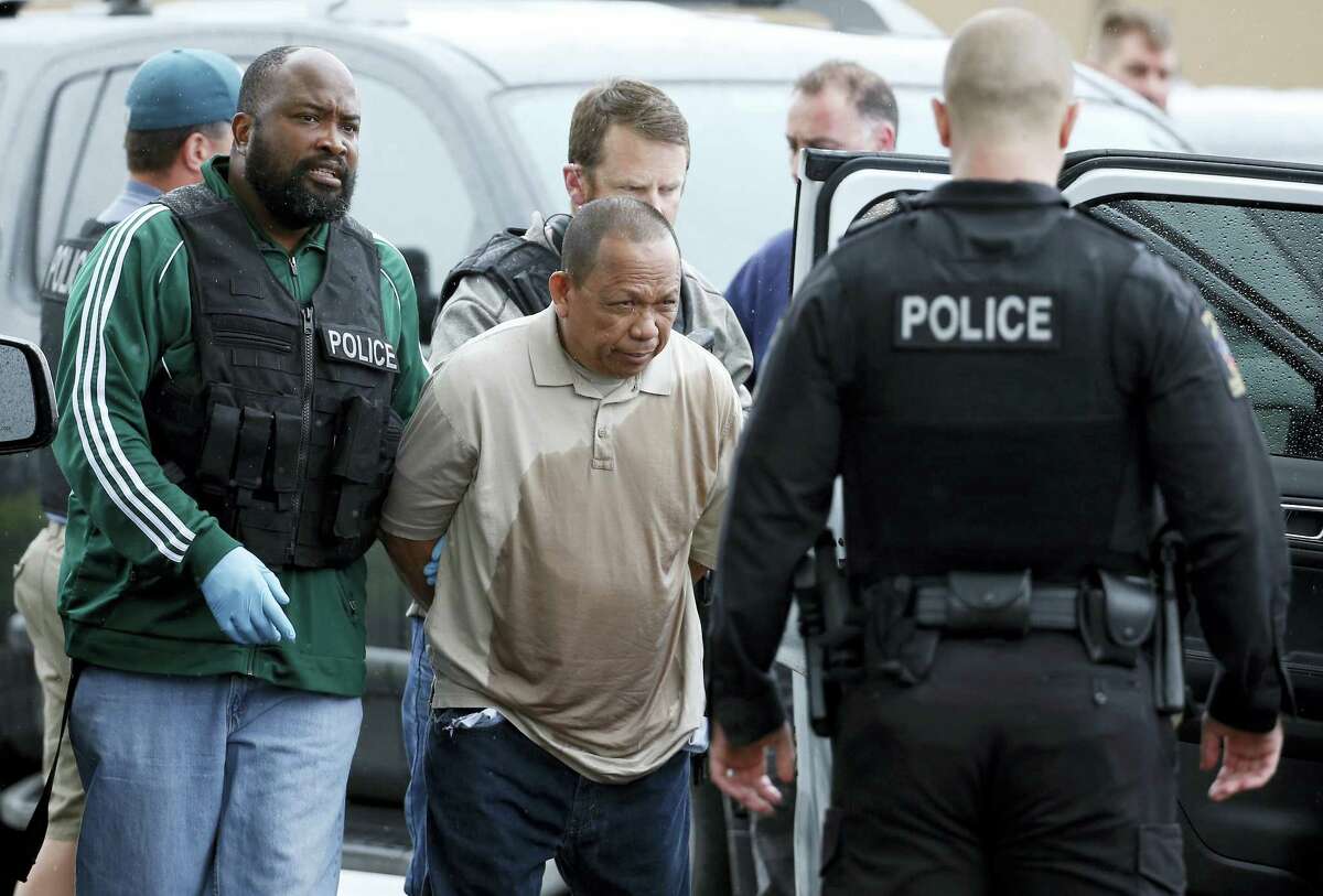 Police take Eulalio Tordil, 62, a suspect in three fatal shootings in the Washington, D.C., area into custody in Silver Spring, Md., Friday, May 6, 2016. Tordil is an employee of the Federal Protective Service, which provides security at federal properties. He was put on administrative duties in March after a protective order was issued against him.