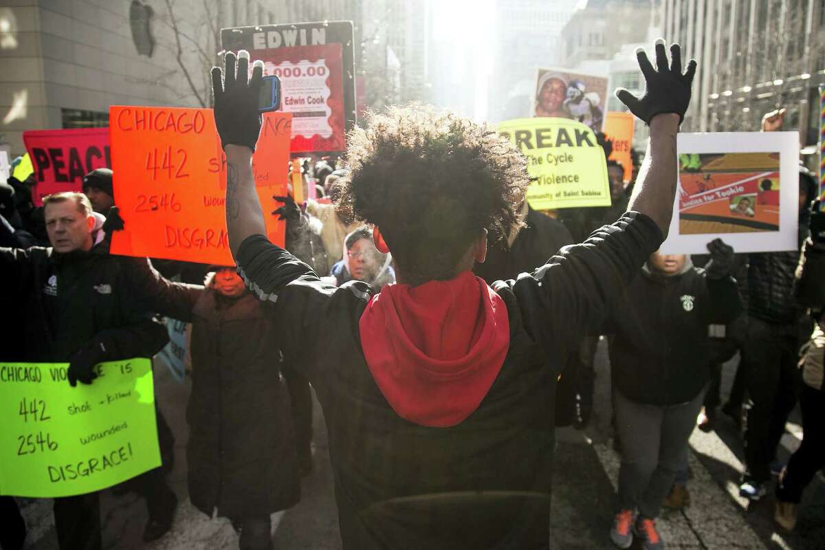 Community activist, 16-year-old Lamon Reccord, center, protests against gun violence in Chicago on Dec. 31.