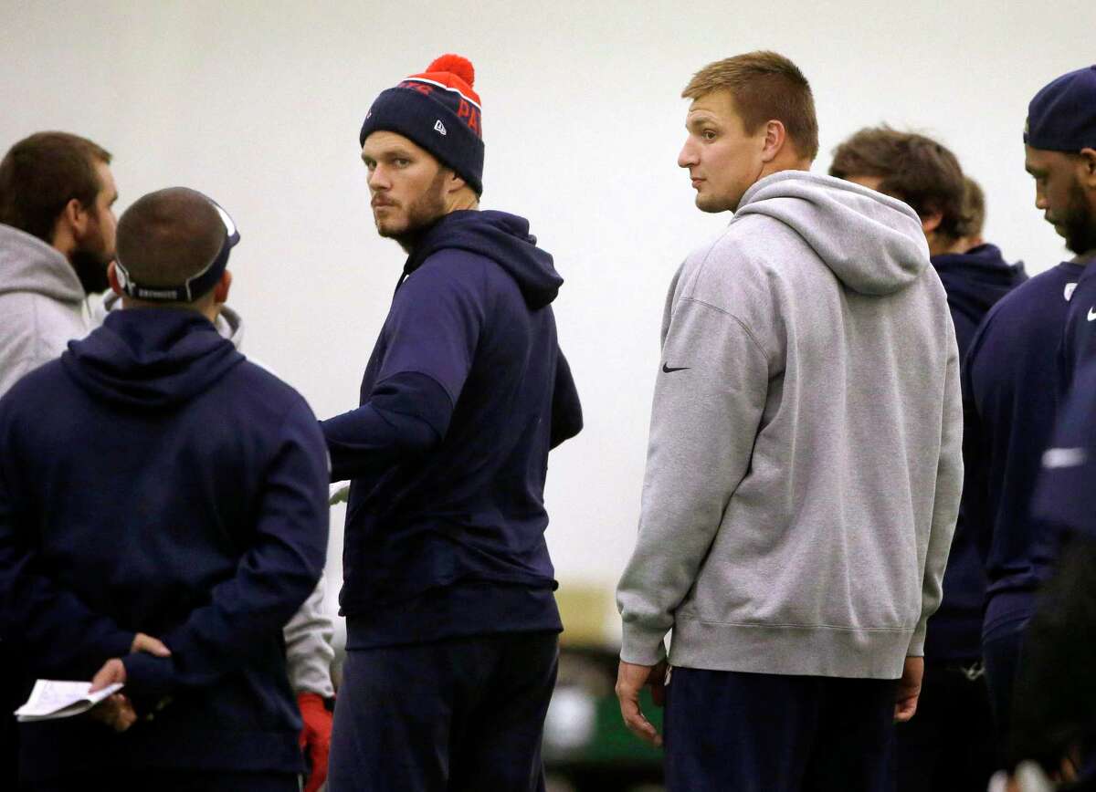 New England Patriots quarterback Tom Brady, center left, and tight end Rob Gronkowski, center right, participate in practice Tuesday in Foxborough, Mass.