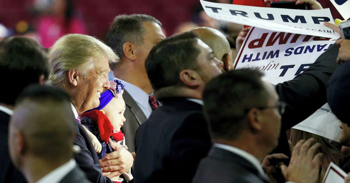 Republican presidential candidate Donald Trump holds a baby during a rally in Charleston, W.Va., Thursday.