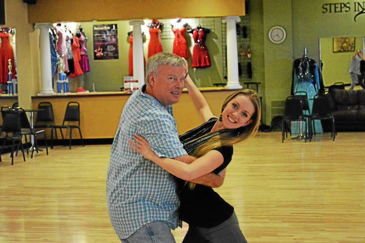 Winsted Town Manager Dale Martin practices his routine with instructor Amy Wylie.