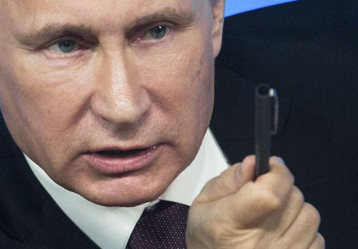 Russian President Vladimir Putin gestures during a news conference in Moscow, Russia.