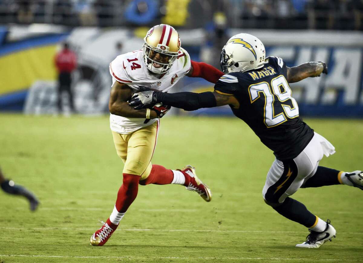 San Francisco 49ers wide receiver Eric Rogers, left, pushes off San Diego Chargers cornerback Craig Mager during the first half of an NFL preseason football game on Sept. 1, 2016 in San Diego.