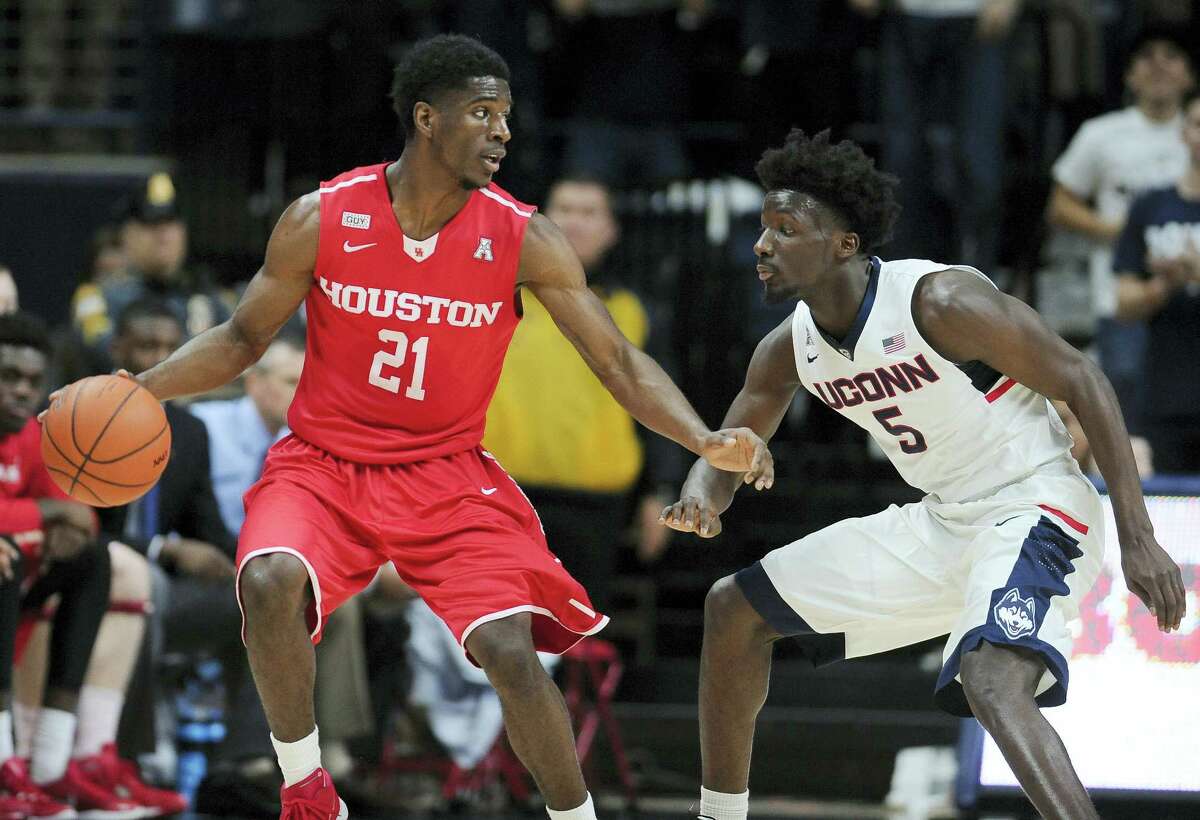 Houston’s Damyean Dotson dribbles as Connecticut's Daniel Hamilton defends in the second half of an NCAA college basketball game, Sunday, Feb. 28, 2016, in Storrs, Conn. Houston won 75-68. (AP Photo/Jessica Hill)