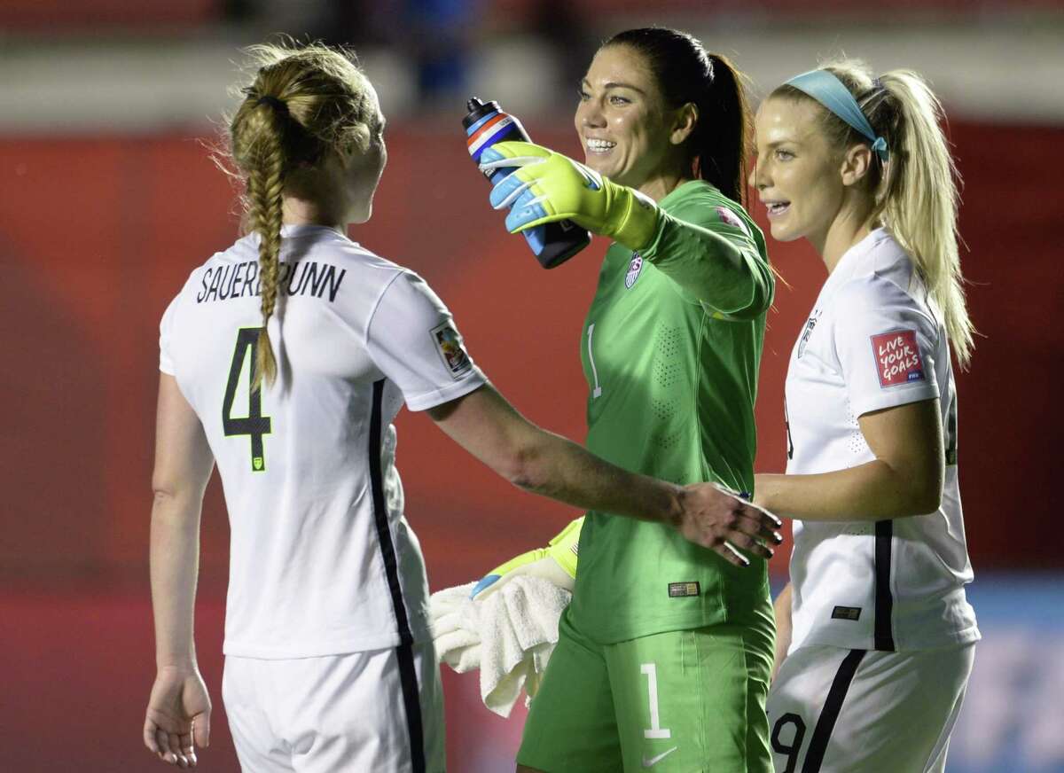 U.S. goalie Hope Solo and teammates Julie Johnston (19) and Becky Sauerbrunn (4) celebrate the team’s win over China on Friday.