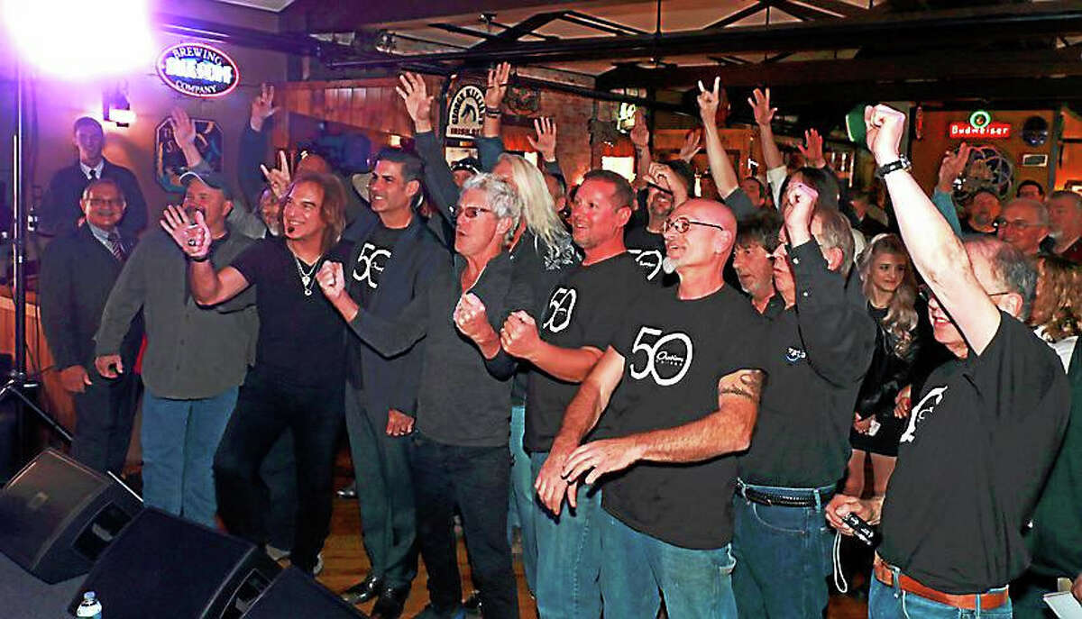 Members of REO Speedwagon, employees of Drum Workshop Inc. and fans celebrate the formal re-launch of production at Ovation Guitars in New Hartford. The event took place at The Parrott Delaney Tavern, located across the lot from Ovation at the Hurley Business Park on Greenwoods Road.