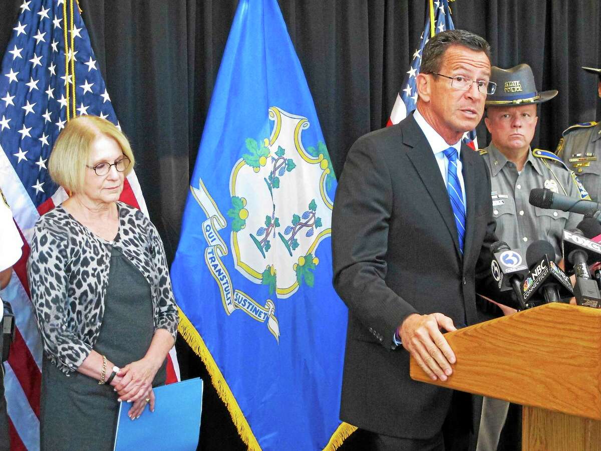 Connecticut Gov. Dannel P. Malloy, front right, discusses a decrease over the previous year in violent crime in the state on Sept. 28, 2015 in Middletown, Conn.