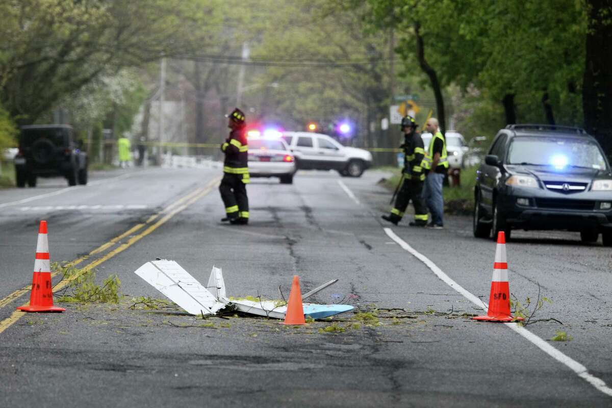 Traffic cones mark the position of pieces from a Beech BE-35 light plane after the aircraft crashed in a residential neighborhood in Syosset, N.Y., Tuesday, May 3, 2016. A spokesman for the Federal Aviation Administration said the plane that had taken off from Myrtle Beach, S.C. and was headed to Robertson Field, an airport in Plainville. All three aboard the plane died in the crash.