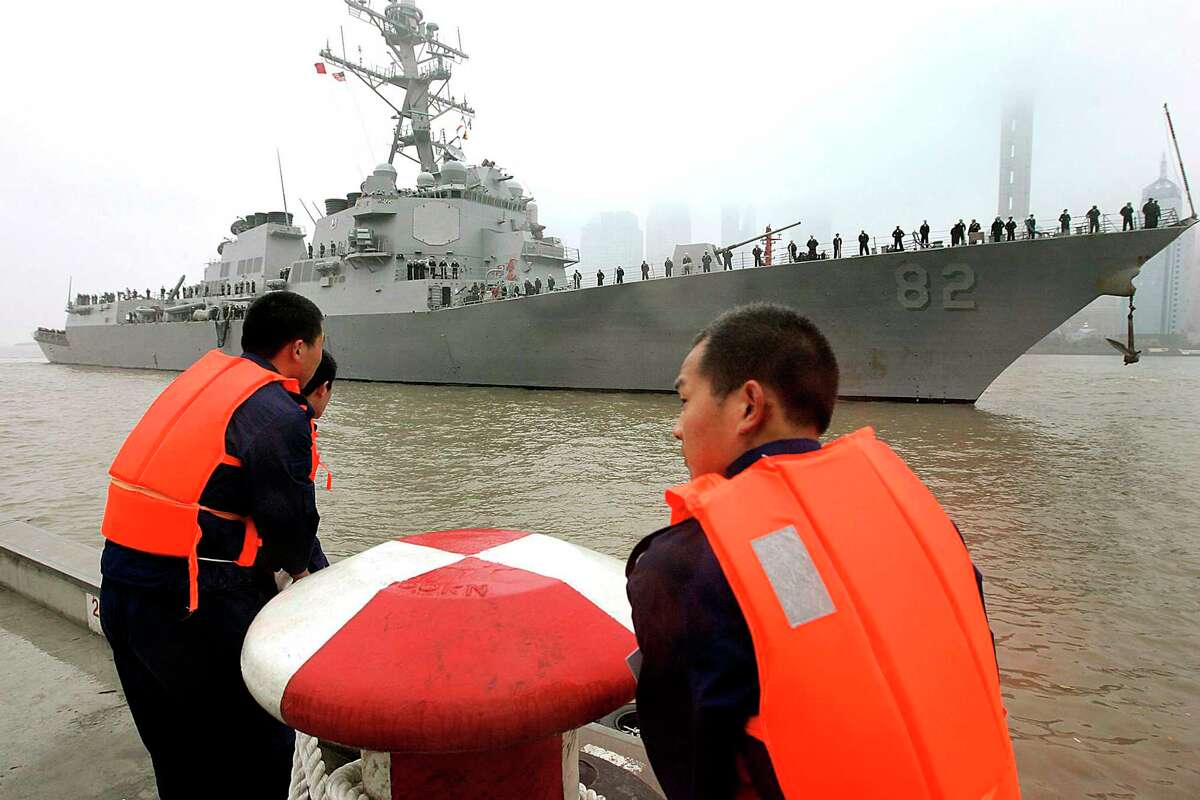 In this April 8, 2008, file photo, Chinese navy personnel get ready for U.S. Navy guided missile destroyer USS Lassen to dock at the Shanghai International Passenger Quay in Shanghai, China, for a scheduled port visit. The USS Lassen sailed past one of China’s artificial islands in the South China Sea on Tuesday, Oct. 27, 2015, in a challenge to Chinese sovereignty claims that drew an angry protest from Beijing, which said the move damaged US-China relations and regional peace.