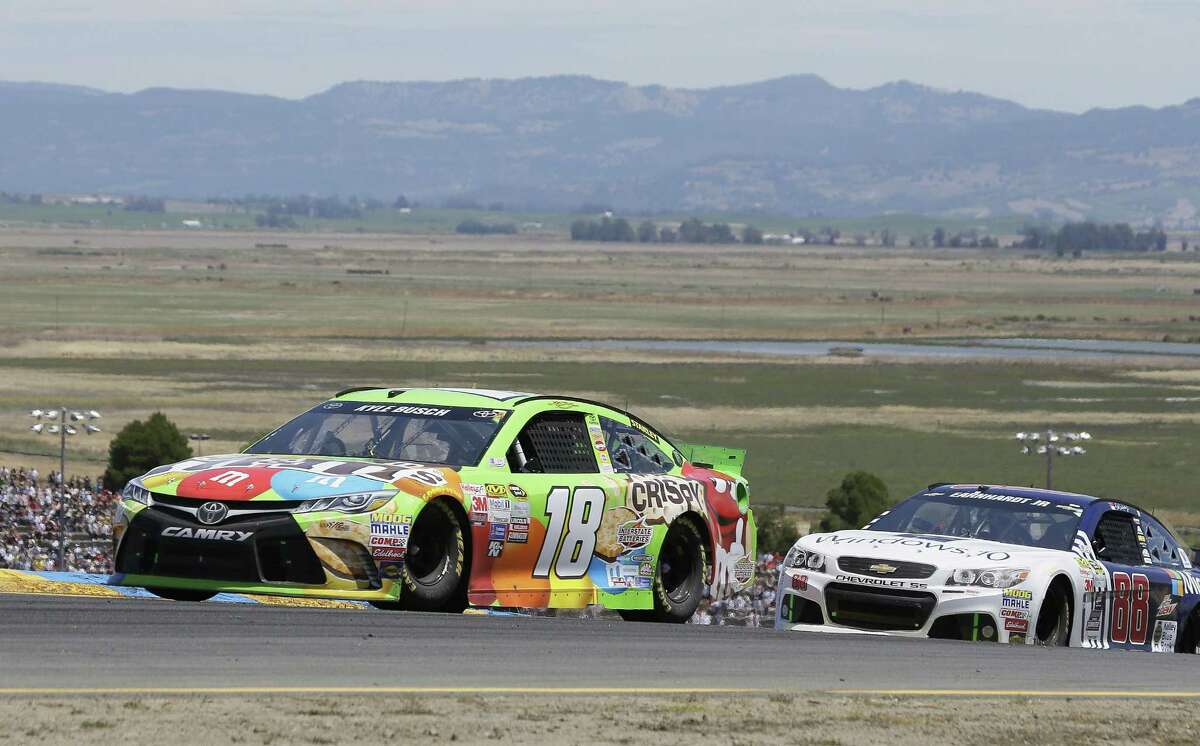 Kyle Busch (18) leads Dale Earnhardt Jr. through turn 2 during the NASCAR Sprint Cup Series race Sunday in Sonoma, Calif. Busch won the race.