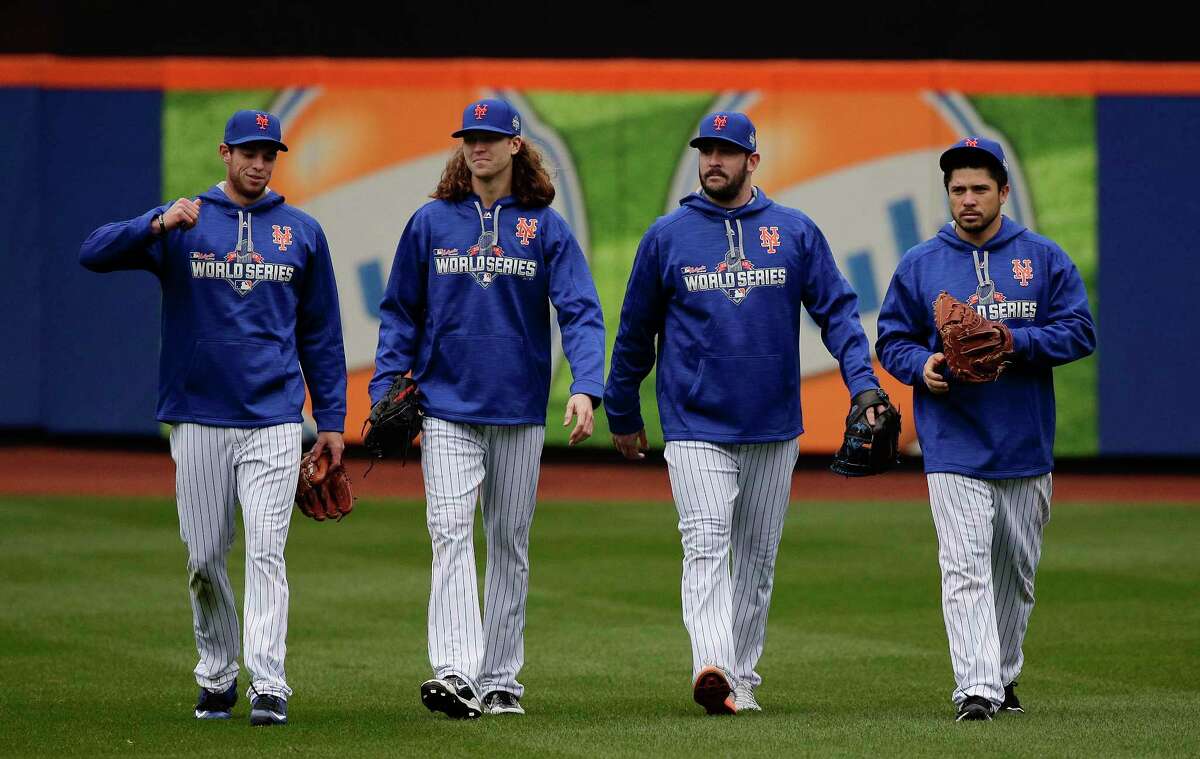 From left, New York Mets pitchers Steven Matz, Jacob deGrom and Matt Harvey and catcher Travis d’Arnaud walk off the field Saturday in New York.