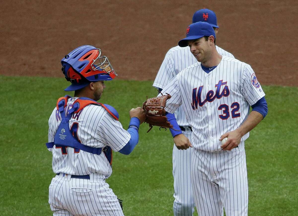 Mets catcher Rene Rivera (44) fist bumps starting pitcher Steven Matz (32) before he leaves the game during the eighth inning against the Braves Wednesday.