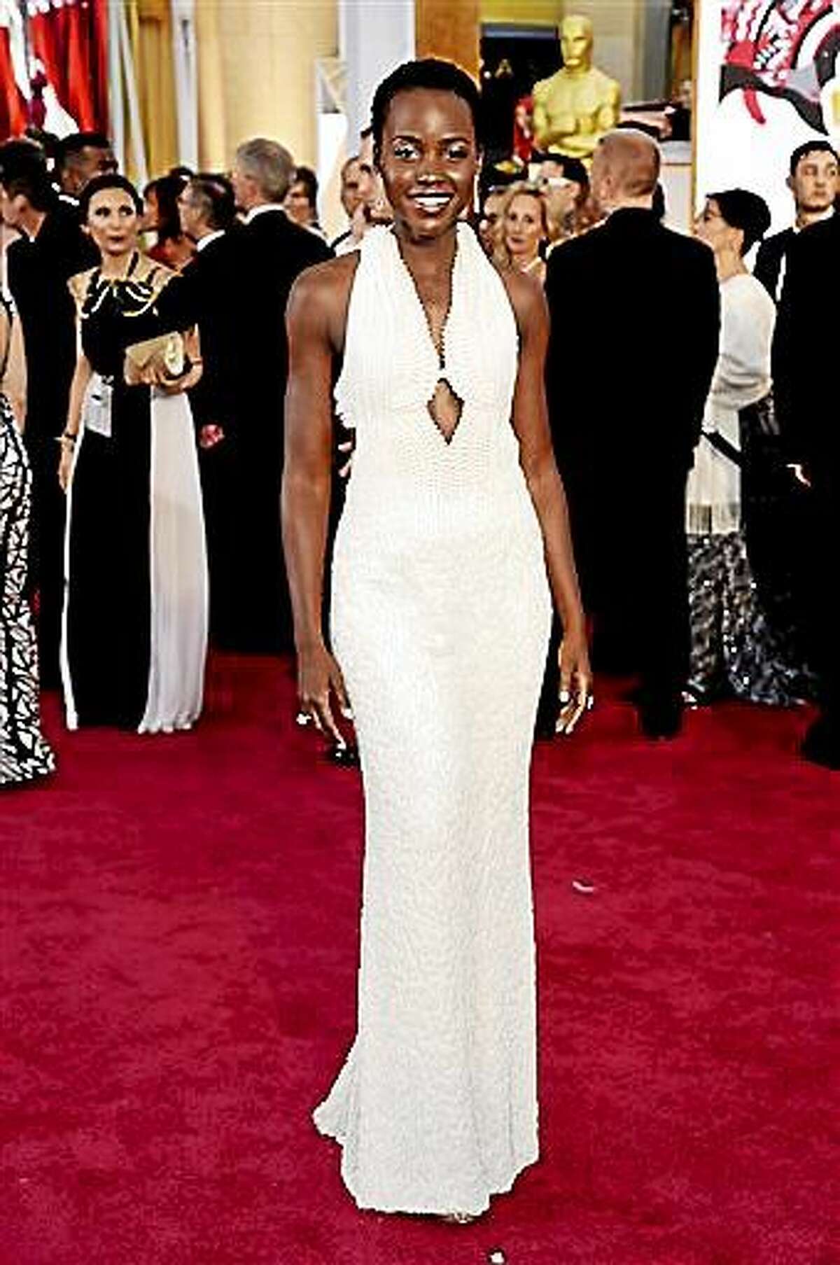 FILE - In this Feb. 22, 2015 file photo, actress Lupita Nyong'o arrives at the Oscars wearing a dress made of pearls at the Dolby Theatre in Los Angeles. Los Angeles sheriff's detectives are investigating the theft of the $150,000 custom Calvin Klein dress worn by Nyong'o at the 2015 Academy Awards. The dress was reported stolen from Nyong'o's West Hollywood hotel room late on Wednesday Feb. 25, 2015. (Photo by Chris Pizzello/Invision/AP, File)
