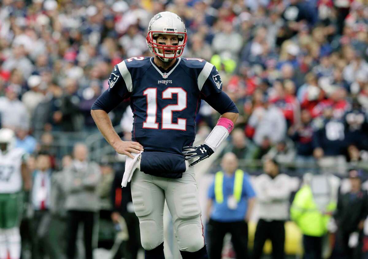 New England Patriots quarterback Tom Brady stands on the field during the first half Sunday in Foxborough, Mass.
