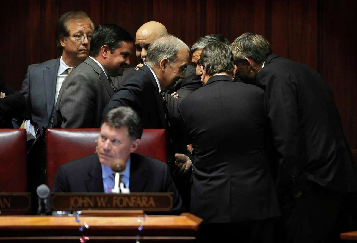 Connecticut Senate Minority Leader Len Fasano, center right, R-North Haven, talks with State Senate President Martin Looney, center left, D-New Haven, in a huddle with other legislators in the Senate Chambers at Capitol on the final day of session on June 3, 2015 in Hartford, Conn.