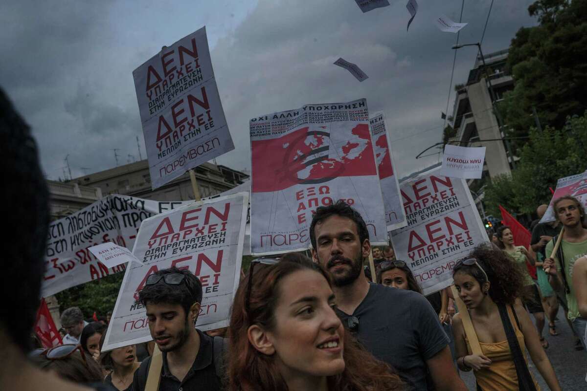 Members of left wing parties hold placards read in Greek ‘There is no future in the European Union’ during a protest in Athens on Sunday, June 28, 2015. Greek Prime Minister Alexis Tsipras says the Bank of Greece has recommended that banks remain closed and restrictions be imposed on transactions, after the European Central Bank didn’t increase the amount of emergency liquidity the lenders can access from the central bank.