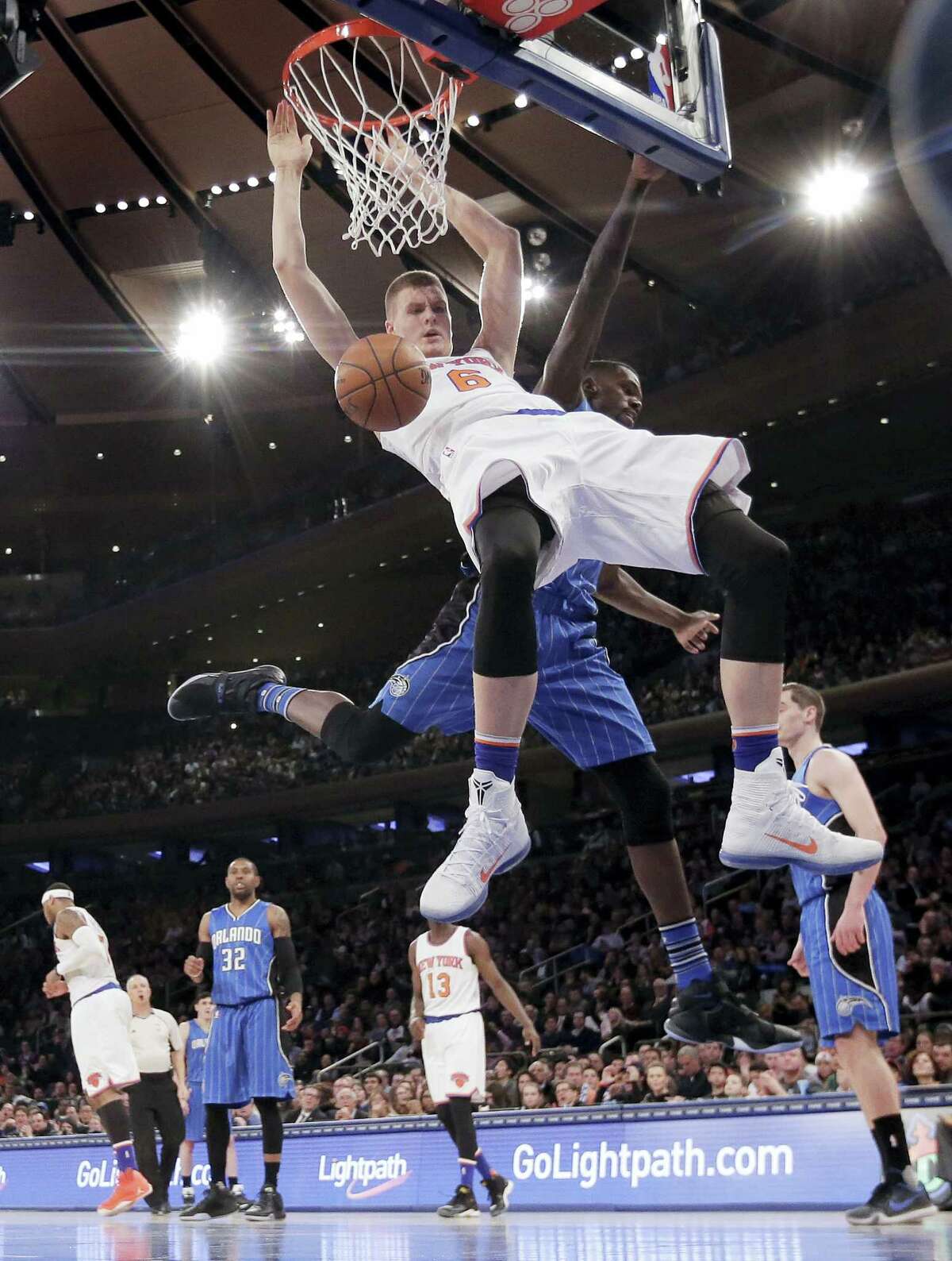Knicks forward Kristaps Porzingis dunks against Magic center Dewayne Dedmon during the fourth quarter on Friday.