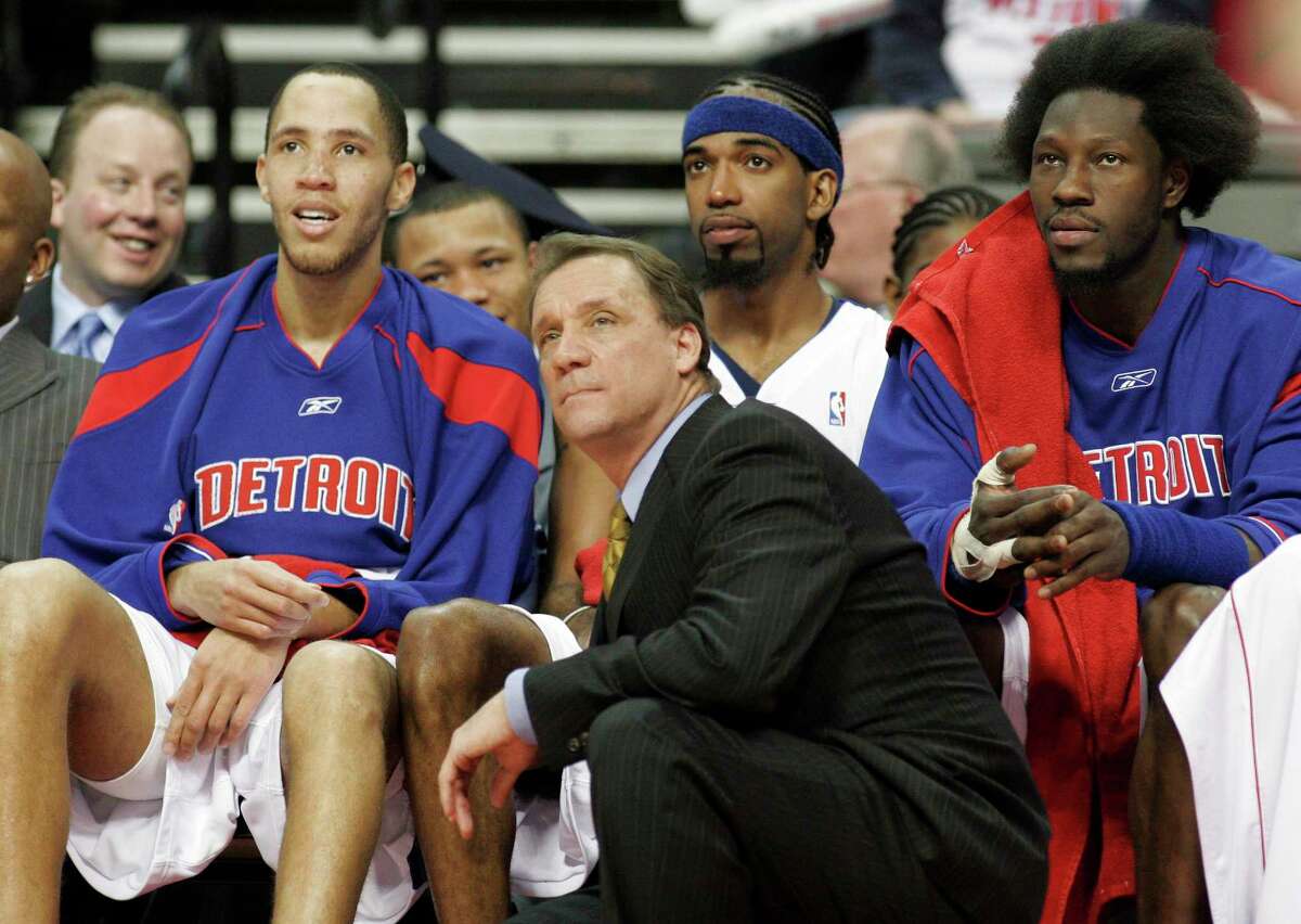 In this April 26, 2006 photo, Detroit Pistons coach Flip Saunders, front, and players, from left, Tayshaun Prince, Richard Hamilton and Ben Wallace watch the final minutes of Game 2 of their Eastern Conference first-round NBA playoff basketball game against the Milwaukee Bucks in Auburn Hills, Mich.