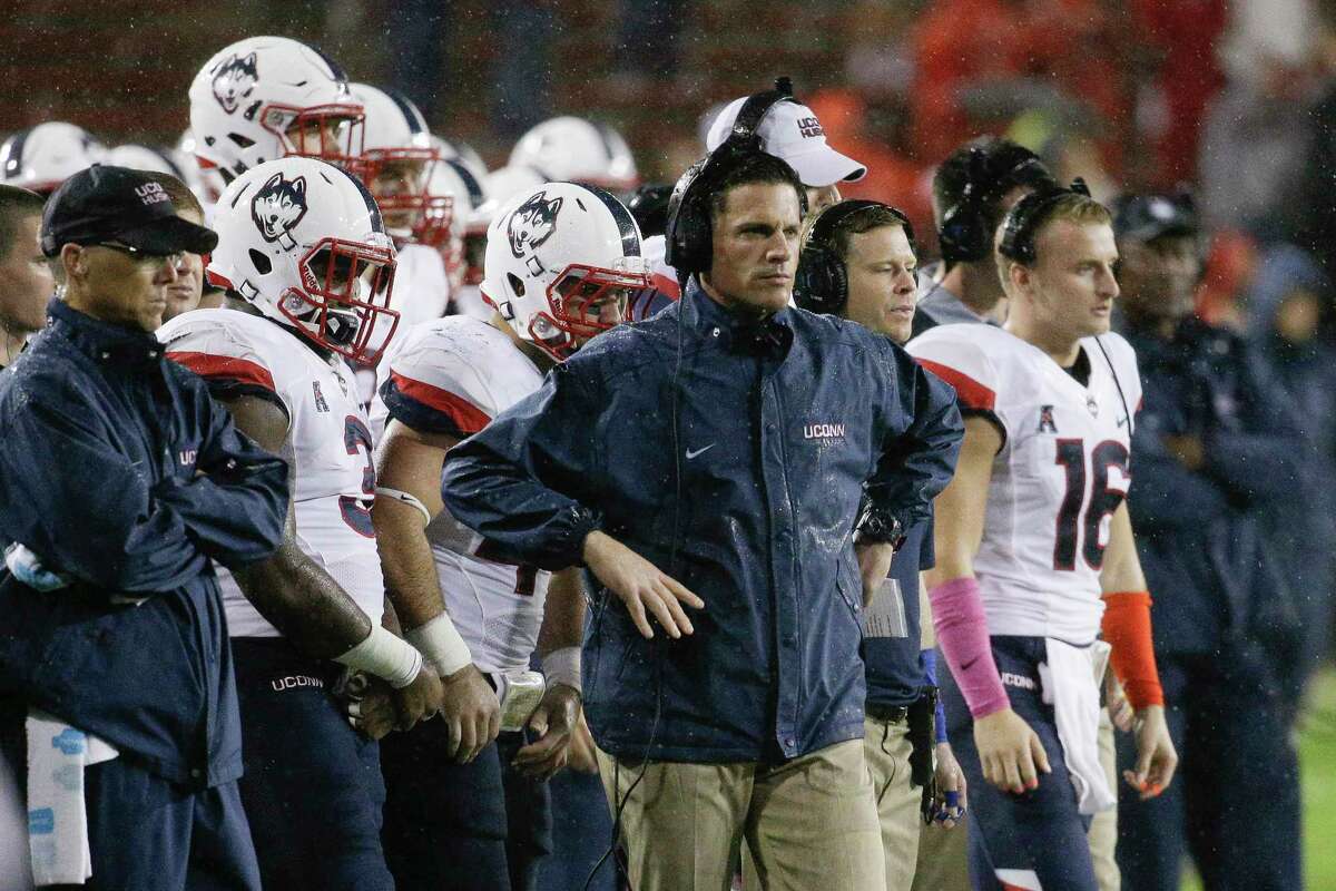 UConn head coach Bob Diaco, center, looks on from the sidelines in the second half against Cincinnati on Saturday,