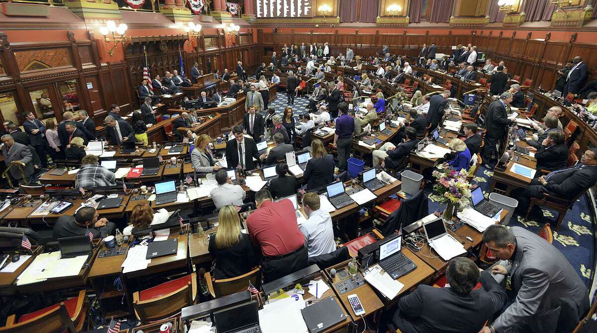 Lawmakers work out small last minute bills during the last day of the legislative session in Hartford, Wednesday, May 4, 2016. Democratic leaders scrapped plans Wednesday evening to push through an 11th-hour budget deal on the final day of the legislative session, acknowledging there was not enough time to pass the bill before a fast-approaching midnight adjournment.