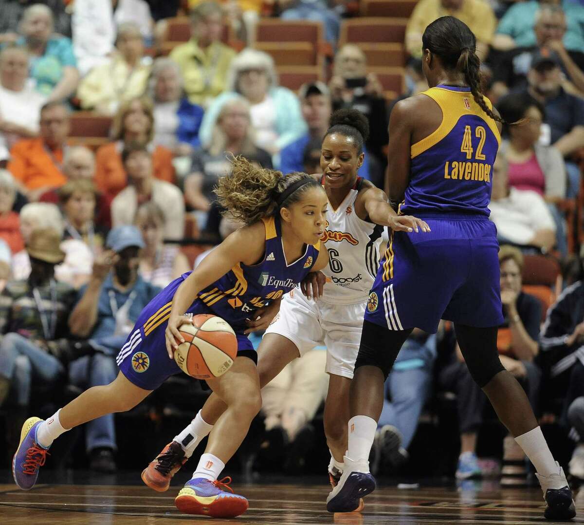 Los Angeles Sparksí Jasmine Lister, left, dribbles around Connecticut Sunís Jasmine Thomas, center, as Sparksí Jantel Lavender sets a pick during the first half of a WNBA basketball game, Friday, June 26, 2015, in Uncasville, Conn. (AP Photo/Jessica Hill)