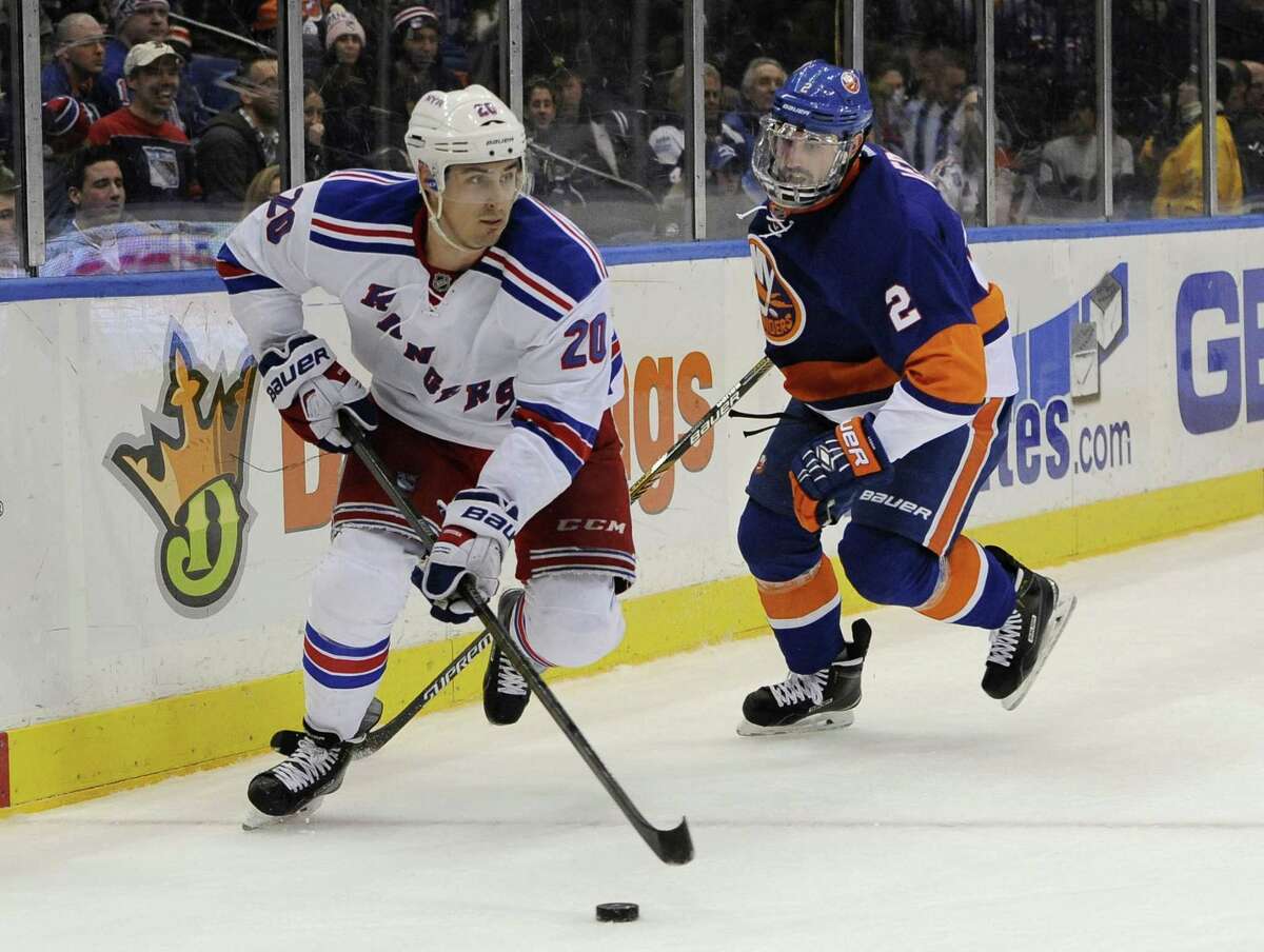 New York Rangers forward Chris Kreider (20) and New York Islanders defenseman Nick Leddy (2) battle during a Feb. 16 game at Nassau Coliseum in Uniondale, N.Y.