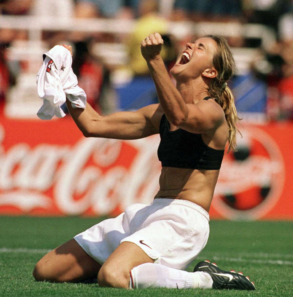 In this July 10, 1999 file photo, the United States’ Brandi Chastain celebrates by taking off her jersey after kicking in the game-winning penalty shootout goal against China in the Women’s World Cup final at the Rose Bowl in Pasadena, Calif.
