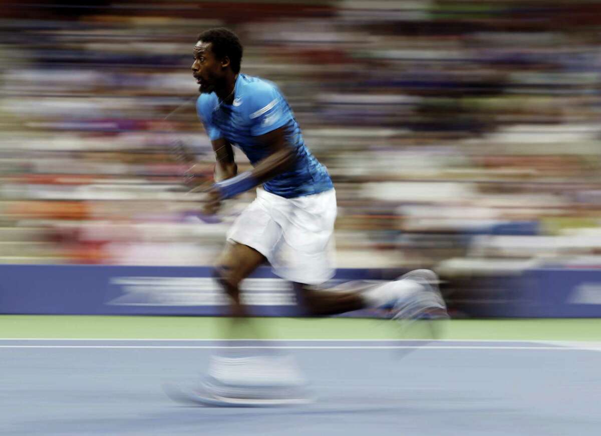 Gael Monfils chases down a shot from Lucas Pouille during the quarterfinals of the U.S. Open tennis tournament Tuesday. Monfils won in straight sets to reach his first U.S. Open semifinal.