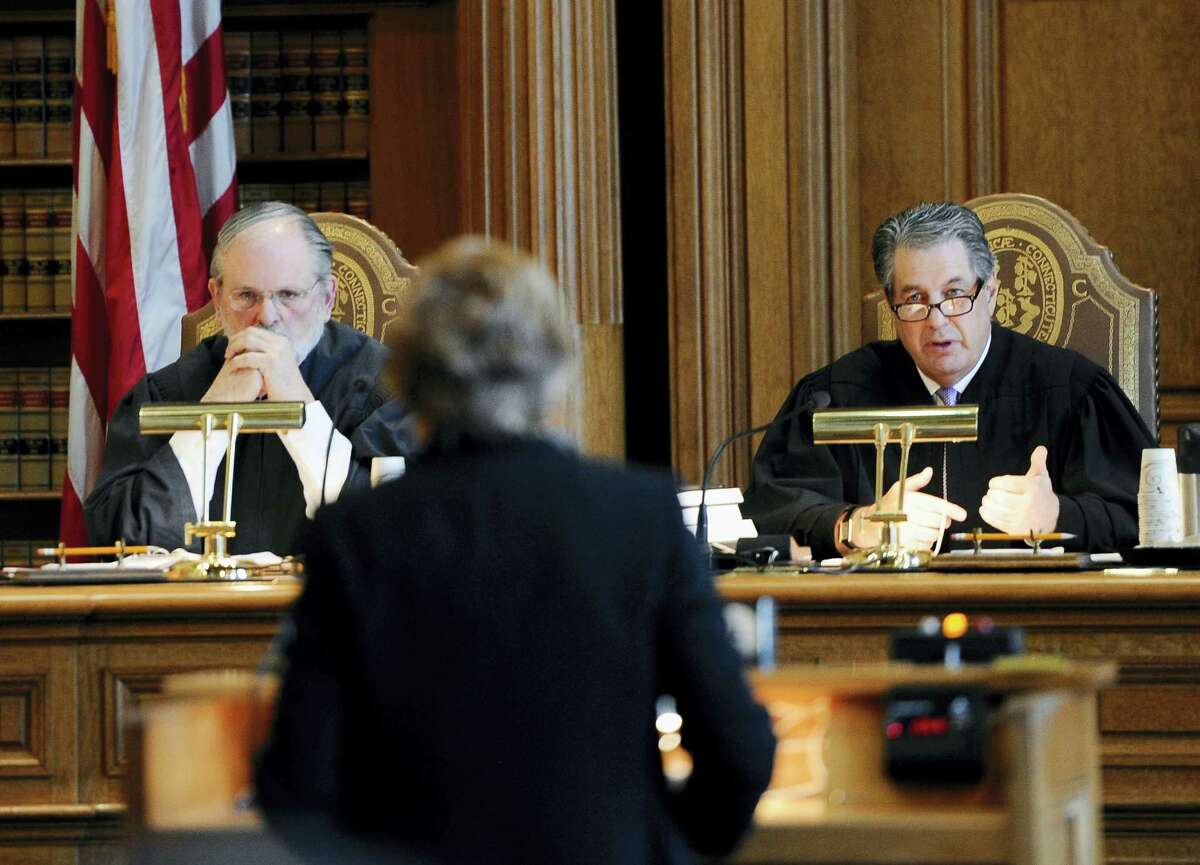 Justice Richard M. Palmer, right, asks a question of prosecutor Susan Gill, center, as Justice Peter T. Zarella, left, listens, during a hearing for Michael Skakel at the state Supreme Court, Wednesday, Feb. 24, 2016, in Hartford. State prosecutors asked the state Supreme Court on to reinstate the 2002 murder conviction against Kennedy cousin Skakel in the bludgeoning death of Martha Moxley when they were teenage neighbors in wealthy Greenwich.